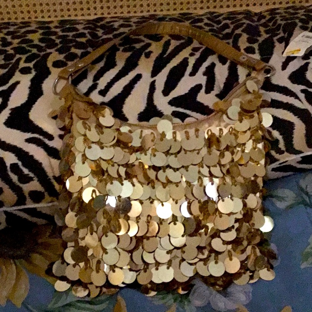 A new Gold shimmering shoulder bag . Great for fun night out & formal occasion